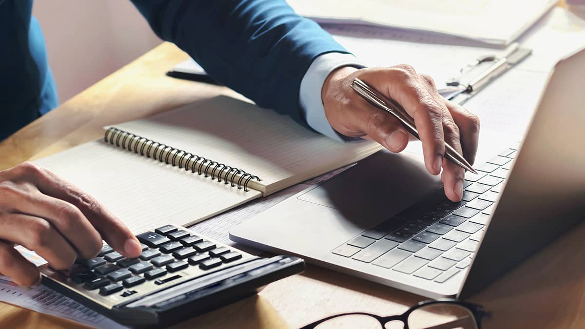 A CPA working through a client's numbers — JG Financial Services